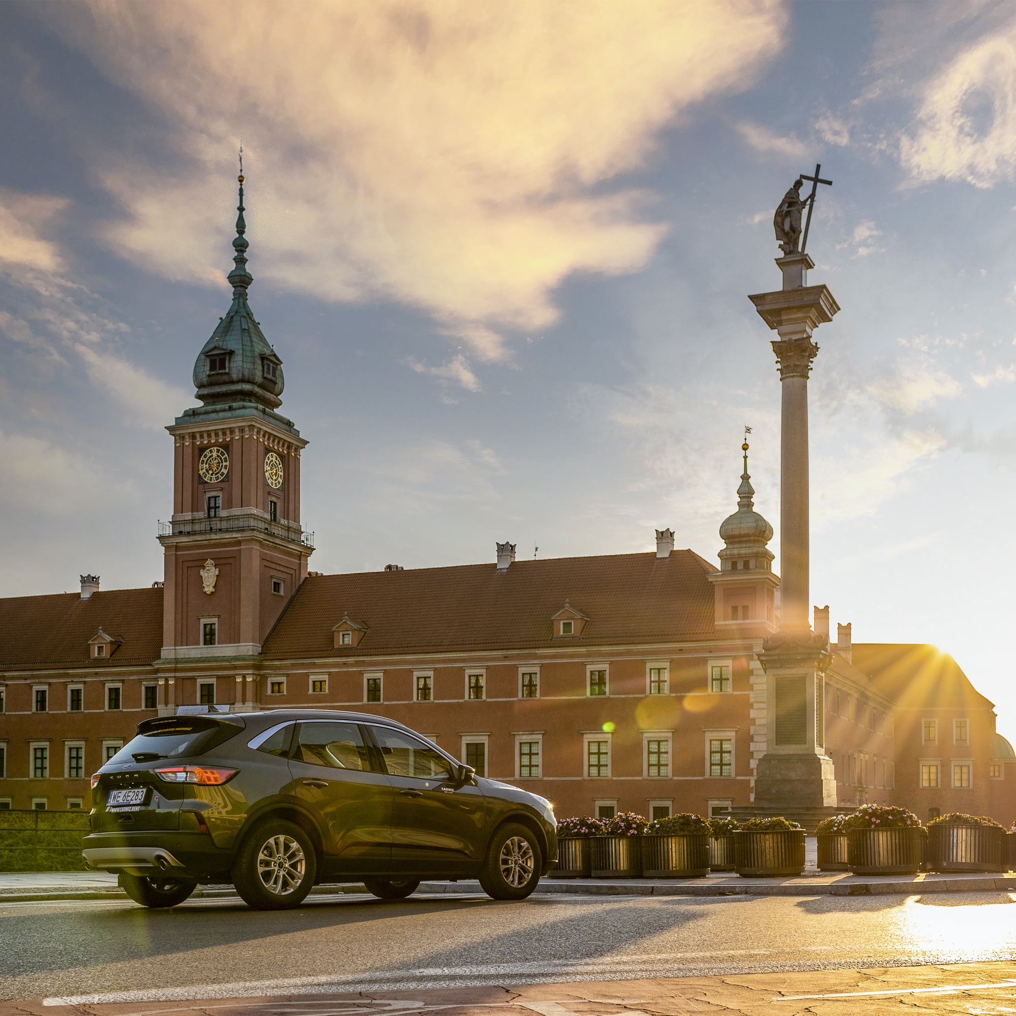 Carwiz Ford Kuga przed Zamkiem Królewskim w Warszawie o zachodzie słońca